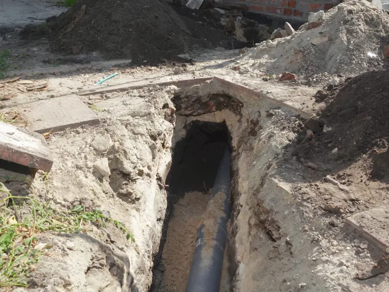 Excavated sewer line with pipe repair access for Sewer Line Repair in Pottstown, PA in Pottstown, PA